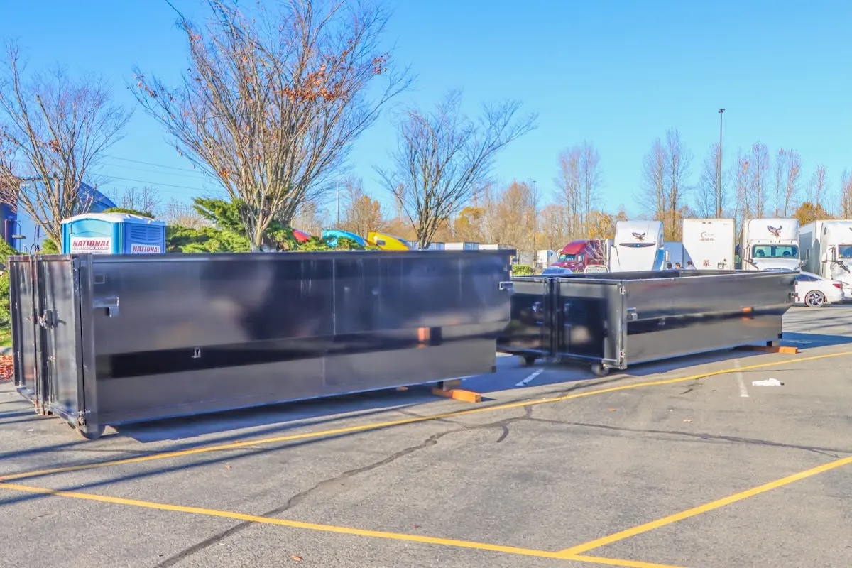 Professional dumpster rental service with roll-off container on residential driveway in Lantana